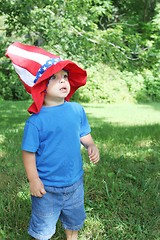 Image showing Little boy wearing big 4th of July hat outside