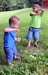 Image showing Two babies with pile of Easter eggs