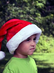 Image showing Boy in green shirt and santa hat