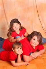 Image showing Three beautiful children in red shirts