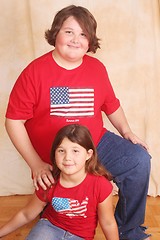 Image showing Teen boy in red and little girl