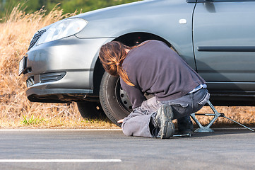 Image showing Young man repairing car outdoors