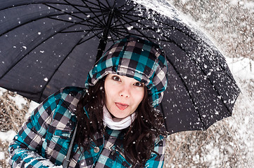 Image showing Girl with umbrella in the snow