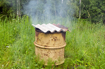 Image showing Smoke rises rusty smokehouse asbestine slate roof 