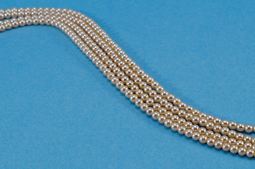 Image showing Pearl collar turn closeup over blue background 