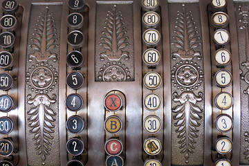 Image showing Antique store silver cash register buttons