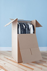 Image showing Wardrobe box with clothing, ready for moving