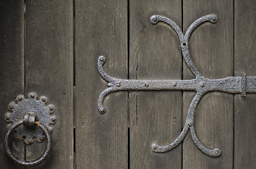 Image showing Wrought Iron metal work on ald wooden door