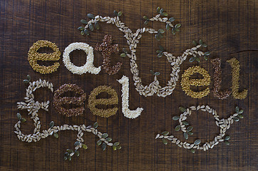 Image showing The phrase 'Eat Well, Be Well', written and decorated in seeds