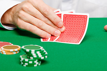 Image showing Man with cards on a gambling table