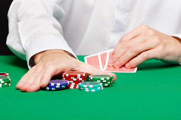 Image showing Man with cards on a gambling table