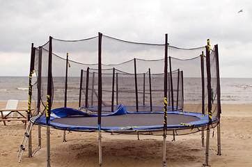 Image showing Trampolines on beach sea sand. Active recreation. 