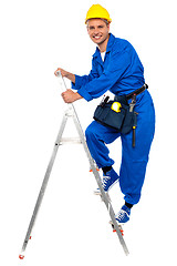 Image showing Repairman climbing up a stepladder