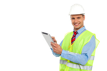 Image showing Construction engineer operating wireless device