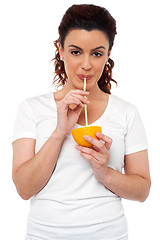 Image showing Active fit girl drinking fresh orange juice