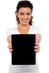 Image showing Woman holding tablet device, showing it to camera