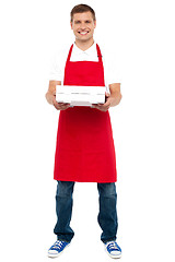 Image showing Full length portrait of male chef holding pie box