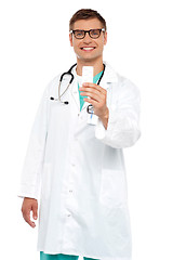 Image showing Smiling doctor showing tablets pack to camera