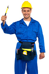 Image showing Smiling young repairman holding hammer