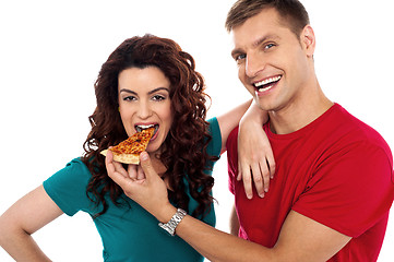 Image showing Boyfriend making her girl eat hot pizza piece