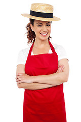 Image showing Young baker woman wearing straw bowler hat