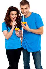 Image showing Young couple drinking orange juice together