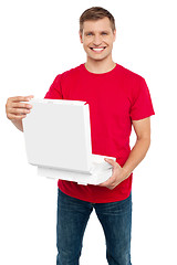 Image showing Smiling casual man holding pizza box