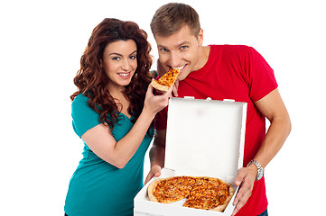 Image showing Pretty woman making her boyfriend end pizza piece