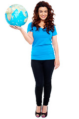 Image showing Stylish trendy girl posing with globe in hand