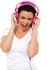 Image showing Brunette women enjoying rocking with loud music