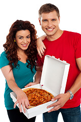 Image showing Cheerful love couple enjoying pizza together