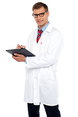 Image showing Handsome doctor writing prescription