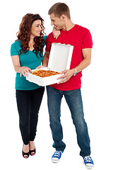 Image showing Love couple sharing pizza. Enjoying together