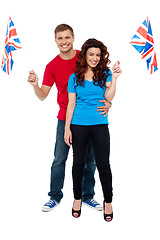 Image showing Guy hugging his girlfriend and both holding UK flag