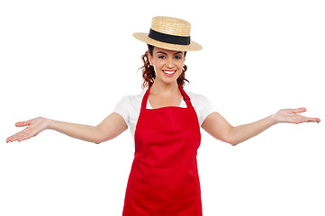 Image showing Pretty chef welcoming you with her arms stretched