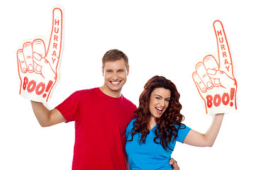 Image showing Young couple showing boo hurray foam hand