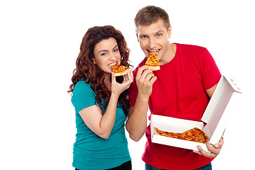 Image showing Adorable young couple relishing yummy pizza