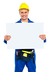 Image showing Construction worker holding blank billboard