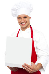 Image showing Portrait of a chef holding a pastry box