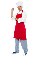 Image showing Young smart chef pointing index finger upwards