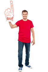 Image showing Casual guy showing large pointy boo hurray hand