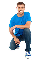 Image showing Casual cool young guy semi seated on floor