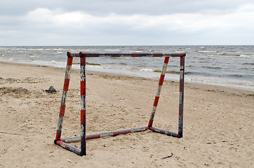 Image showing Steel metal football goal gate on sea sand 