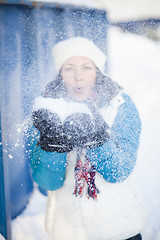 Image showing Woman blowing snow