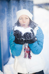 Image showing Woman blowing snow