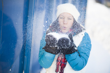 Image showing Woman blowing snow