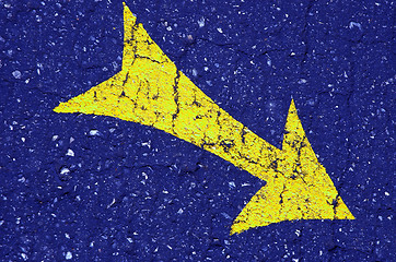 Image showing yellow arrow on the blue asphalt