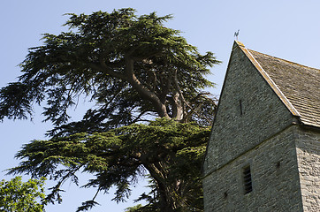 Image showing Church Tower with saddleback, slate tiled roof next to enourmous