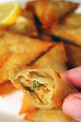 Image showing Eating a samosa