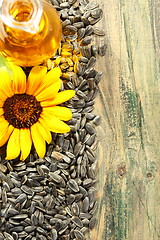 Image showing Sunflower seeds and oil in bottle.